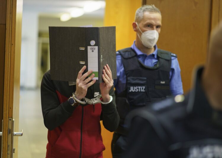 The Iraqi Taha Al-J. is led into the courtroom at Frankfurt's Higher Regional Court before the verdict is pronounced Frankfurt, Germany, Nov. 30, 2021.