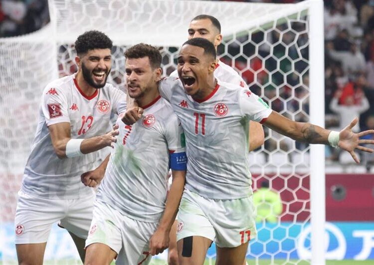Tunisia's players celebrate after scoring during the FIFA Arab Cup quarter-final match against Oman at the Education City Stadium in the Qatari city of Ar-Rayyan.