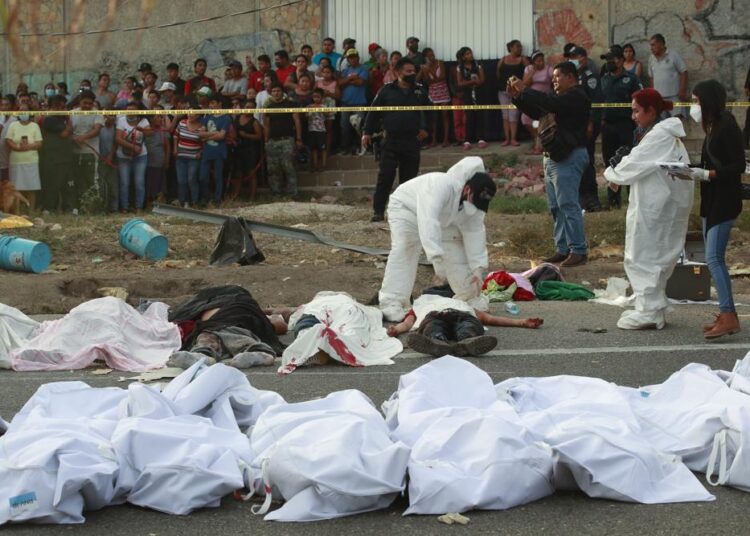 Migrant truck crashes in Mexico killing 54 1 - Egyptian Gazette Bodies in body bags are placed on the side of the road after an accident in Tuxtla Gutierrez, Chiapas state, Mexico.