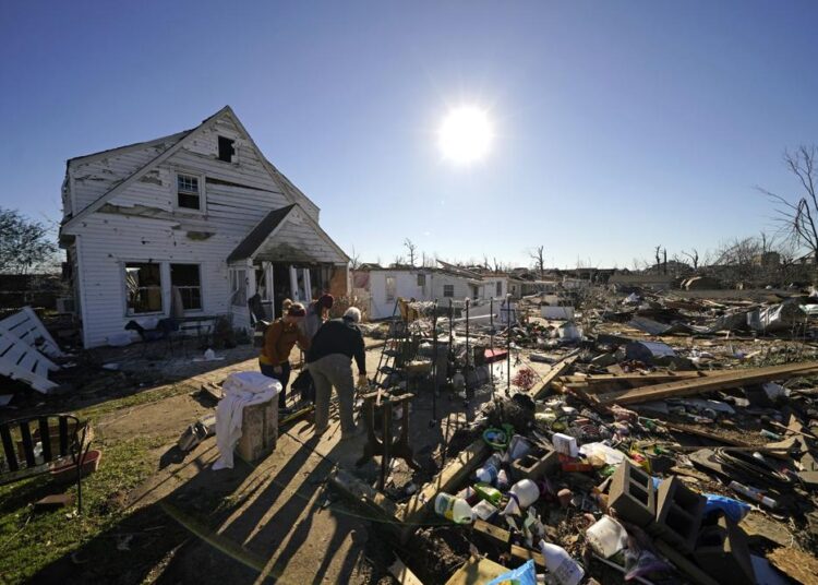 Tornado-slammed parts of Kentucky face long recovery 1 - Egyptian Gazette Volunteers, mostly employees from the Mayfield Consumer Products factory, help salvage possessions from the destroyed home of Martha Thomas, in the aftermath of tornadoes that tore through the region several days earlier, in Mayfield, Ky., Monday, December 13, 2021.