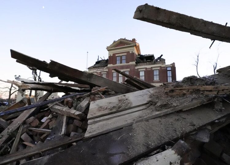Debris is piled around the the damaged Graves County Courthouse, December 12, 2021, in Mayfield, Ky. Tornadoes and severe weather caused catastrophic damage across several states Friday, killing multiple people.