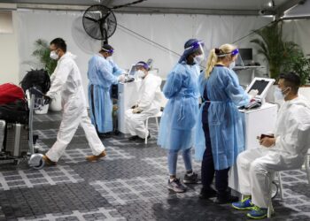 WHO: Vaccination, not travel curbs, key to battling Omicron