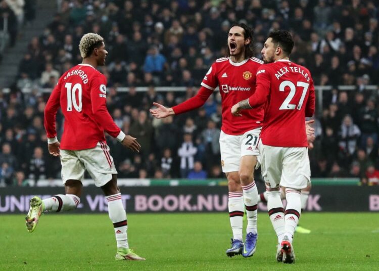 Manchester United's Edinson Cavani celebrates scoring their first goal against Newcastle United with Alex Telles and Marcus Rashford at St James’ Park, Newcastle.