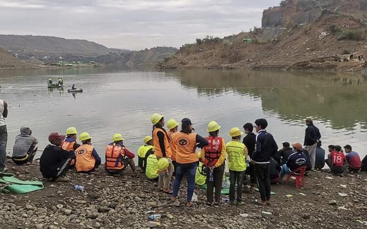 Members of rescue team search for missing people at a jade mining area Wednesday, Dec. 22, 2021, in Hpakant, Kachin State, northern Myanmar. A landslide at a remote jade mine in northern Myanmar's Kachin state Wednesday, Dec. 22, 2021, left dozens of people missing and a search and rescue operation was underway, rescue officials said.