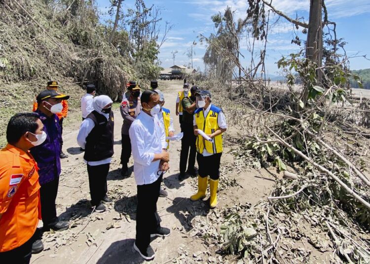 Indonesia bolsters recovery efforts after volcano kills 34 1 - Egyptian Gazette Indonesian President Joko Widodo inspecting an area covered in ash from the eruption of Mount Semeru in Lumajang district, East Java province, Tuesday, Dec. 7, 2021.