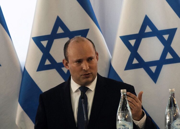 Israeli Prime Minister Naftali Bennett speaks at the weekly cabinet meeting in Kibbutz Mevo Hama in the Israeli-occupied Golan Heights, December 26, 2021.