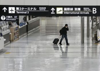 Japan suspends new flight reservations as Omicron spreads