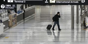 Japan suspends new flight reservations as Omicron spreads