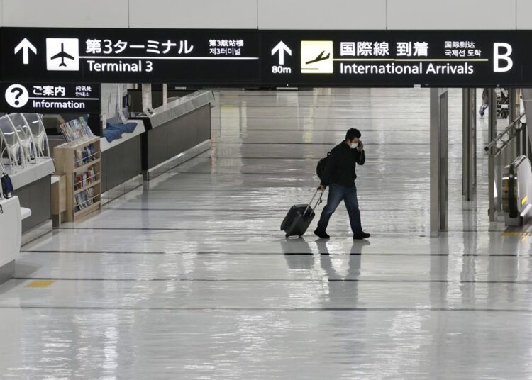 An international arrivals lobby is deserted at Narita International Airport in Narita, east of Tokyo, Japan, Monday, Nov. 29, 2021. Japan’s NHK national television said the country’s transport ministry on Wednesday, Dec. 1, requested international airlines to stop taking new reservations for all flights arriving in Japan until the end of December.
