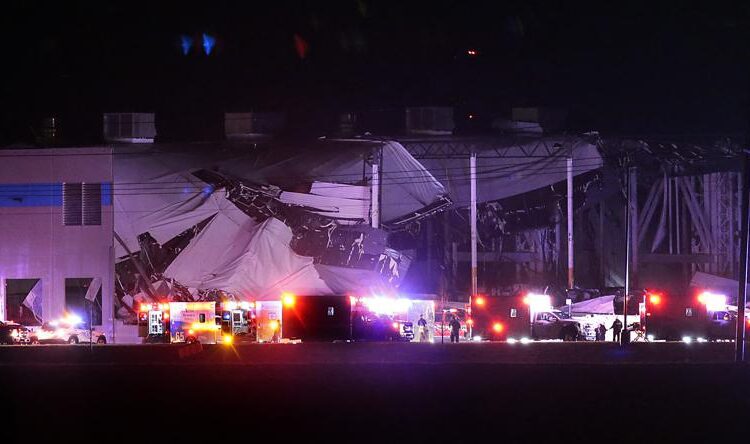 The Amazon distribution center is partially collapsed after being hit by a tornado yesterday in Edwardsville, Ill.