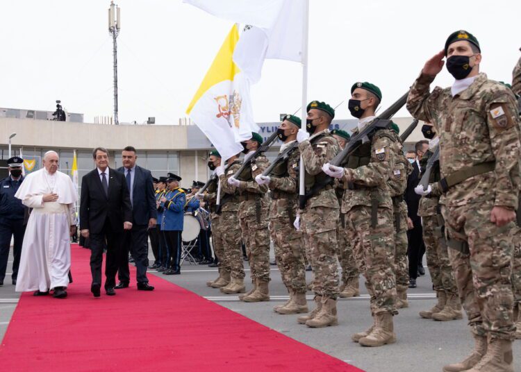 Cyprus President Nicos Anastasiades accompanies Pope Francis during a farewell ceremony before departing to Athens at the Larnaca International Airport in Larnaca, Cyprus yesterday.
