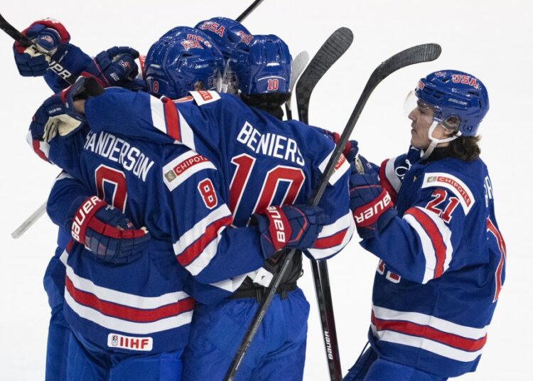 United States' players celebrate after scoring against Slovakia during first period IIHF World Junior Hockey Championship action in Red Deer, Alberta.