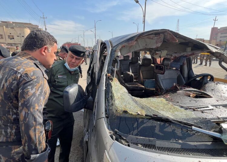 Iraqi security forces inspect the site of an explosion in Basra, Iraq December 7, 2021.