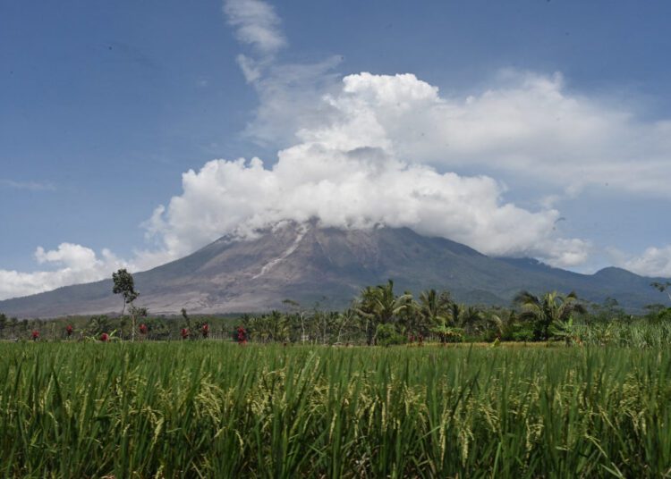Mount Semeru is seen at the Curah Kobokan village in Lumajang December 7, 2021, following the volcano’s eruption that killed at least 22 people.