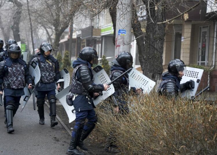 Riot police walk to block demonstrators during a protest in Almaty, Kazakhstan, Wednesday, Jan. 5, 2022. Demonstrators denouncing the doubling of prices for liquefied gas have clashed with police in Kazakhstan's largest city and held protests in about a dozen other cities in the country.