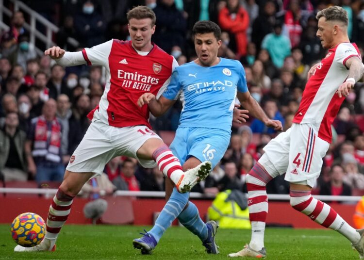 City moves 11 points clear, Spurs close on top four 1 - Egyptian Gazette Manchester City's Rodrigo (C) shoots to score his side’s second goal past Arsenal's Rob Holding (L) and Arsenal's Ben White during their Premier League match at the Emirates Stadium, in London.