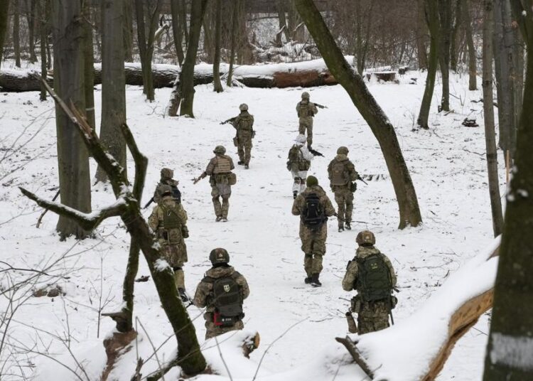 Members of Ukraine's Territorial Defense Forces, volunteer military units of the Armed Forces, train in a city park in Kyiv, Ukraine, Saturday, Jan. 22, 2022.