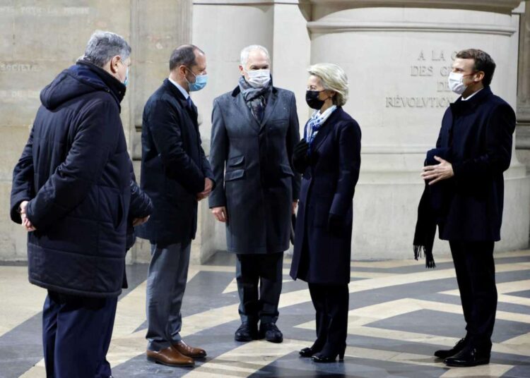 France's President Emmanuel, right, and European Commission President Ursula von der Leyen, second from right, greet Veil's sons and Monnet's grand-son during a ceremony to pay tribute to late French politician Simone Veil and diplomat Jean Monnet at the French Pantheon in Paris, Friday, Jan. 7, 2022.