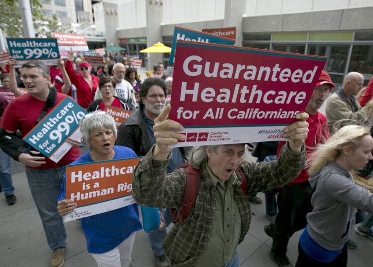 File photo showing supporters of single-payer healthcare march to the Capitol, on April 2017, in Sacramento, California.