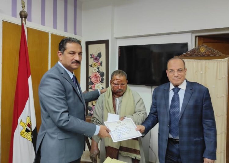 Worker saves Giza school from fire 1 - Egyptian Gazette Under-Secretary of the Ministry of Education in Giza Ashraf Salloma (L) and Chairman of the Council of Parents and Trustees Badawi Allam (R) honouring Abdullah Mohamed Abdullah, a worker who saved a Giza school from fire.