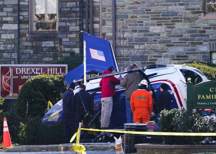 A medical helicopter rests next to the Drexel Hill United Methodist Church after it crashed in the Drexel Hill section of Upper Darby, Pa., on Wednesday, January 12, 2022.