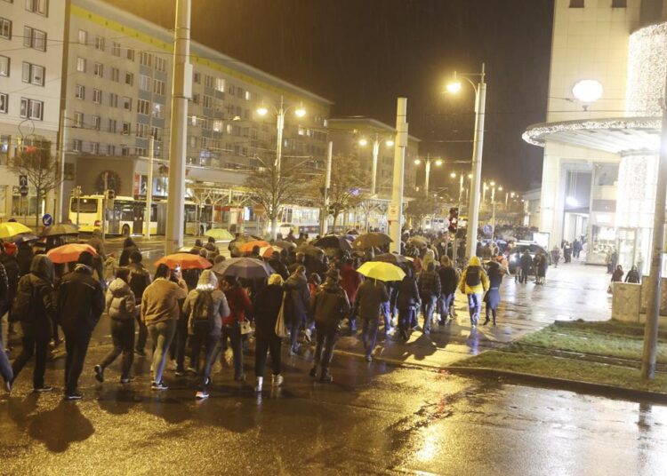 Participants of a so-called walk against the Corona measures walk through the city centre of Gera, Germany, on Monday, January 3, 2022.