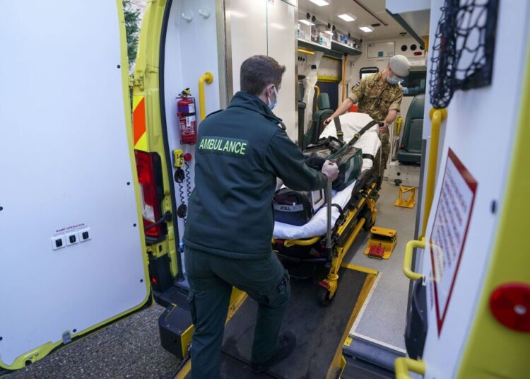UK gov’t cuts COVID isolation period to 5 days, from 7 1 - Egyptian Gazette Military co-responders Lt. Corydon Morrell, background and Major James Allen board an ambulance, at the NHS South Central Ambulance Service Bracknell Ambulance Station in Bracknell, England, on Jan. 12, 2022, where the military personnel are being used to supplement the NHS during staffing shortages resulting from increased isolation due to the Omicron COVID-19 variant.