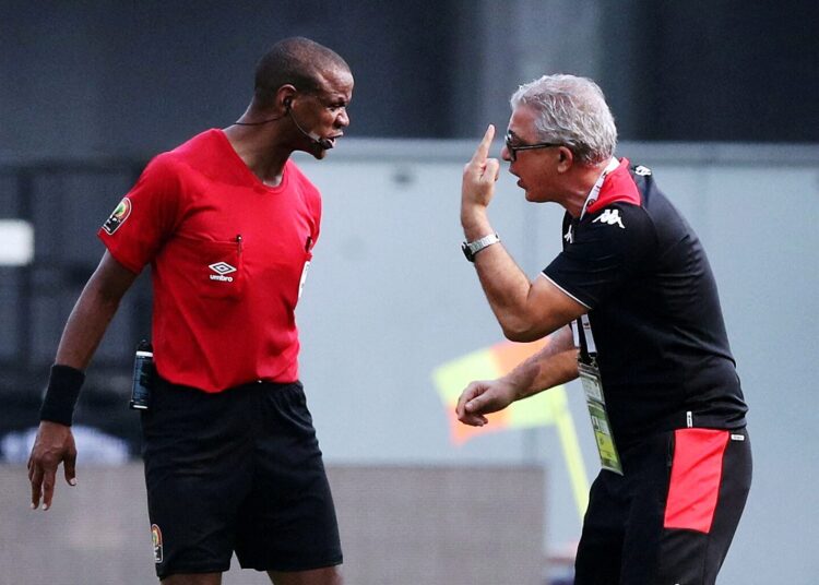 Tunisia's head coach Mondher Kebaier (R) gestures to the referee Janny Sikazwe of Zambia, during the African Cup of Nations 2021 group F match between Tunisia and Mali at the Limbe Omnisport Stadium in Limbe.