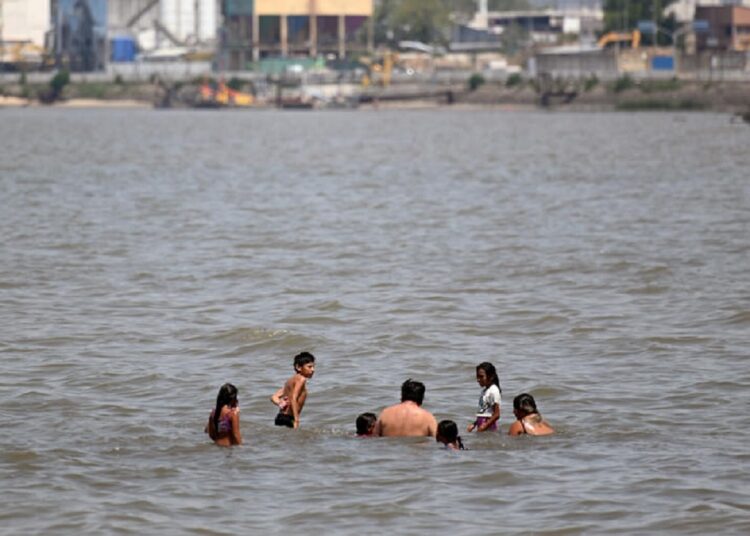 People cool off in Rio de la Plata amid a summer heat wave in Buenos Aires, Argentina.
