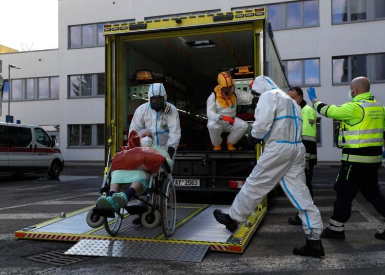 Czechs to let some workers stay on after testing positive 1 - Egyptian Gazette A file photo shows health care workers transport a COVID-19 patient, in Ceska Lipa, Czech Republic, on March 18, 2021.