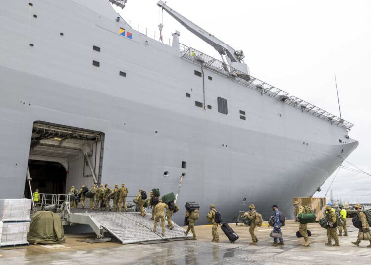 Soldiers load onto HMAS Adelaide at the Port of Brisbane before departing for Tonga Thursday, Jan. 20, 2022, after a volcano eruption.