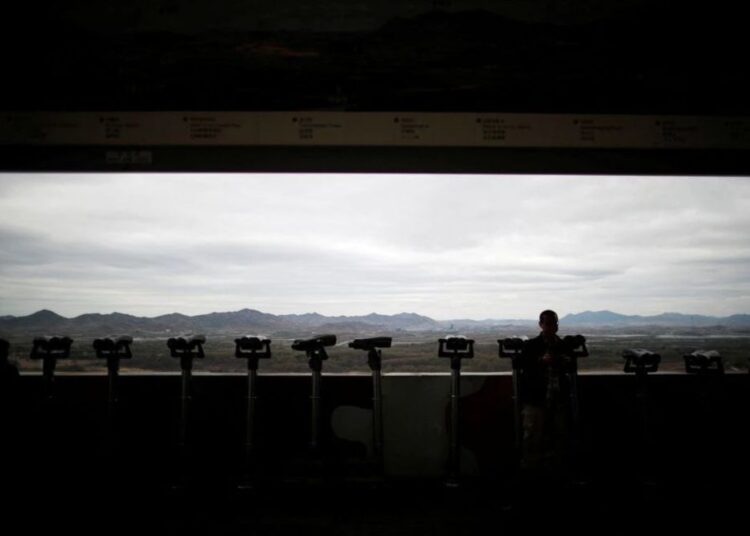 A man standing near binoculars as he tries to see North Korea’s propaganda village of Gijungdong at the Dora observatory near the demilitarised zone separating the two Koreas, in Paju, South Korea, April 24, 2018.