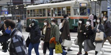 Japan approves new restrictions for areas hard hit by COVID