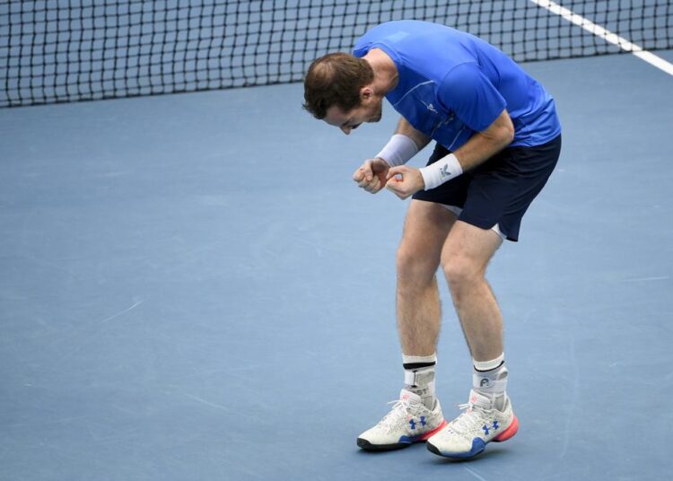 Andy Murray of Britain reacts after defeating Nikoloz Basilashvili of Georgia in their first round match at the Australian Open tennis championships in Melbourne, Australia, Tuesday, Jan. 18, 2022.
