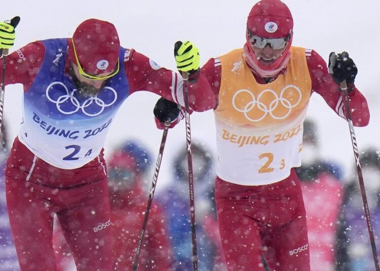 Russians hold off Norway and France for Olympic relay gold 1 - Egyptian Gazette Sergey Ustiugov, of the Russian Olympic Committee, left, and Denis Spitsov, of the Russian Olympic Committee, compete during the men's 4 x 10km relay cross-country skiing competition at the 2022 Winter Olympics, Sunday, Feb. 13, 2022, in Zhangjiakou, China.
