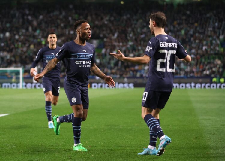 Soccer Football - Champions League - Round of 16 First Leg - Sporting CP v Manchester City - Estadio Jose Alvalade, Lisbon, Portugal - February 15, 2022 Manchester City's Raheem Sterling celebrates scoring their fifth goal with Bernardo Silva Action Images via Reuters/Carl Recine