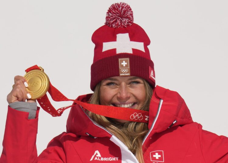 Corinne Suter wins Olympic downhill gold 1 - Egyptian Gazette Corinne Suter, of Switzerland, gold, reacts during the medal ceremony for the women's downhill at the 2022 Winter Olympics, Tuesday, Feb. 15, 2022, in Beijing.