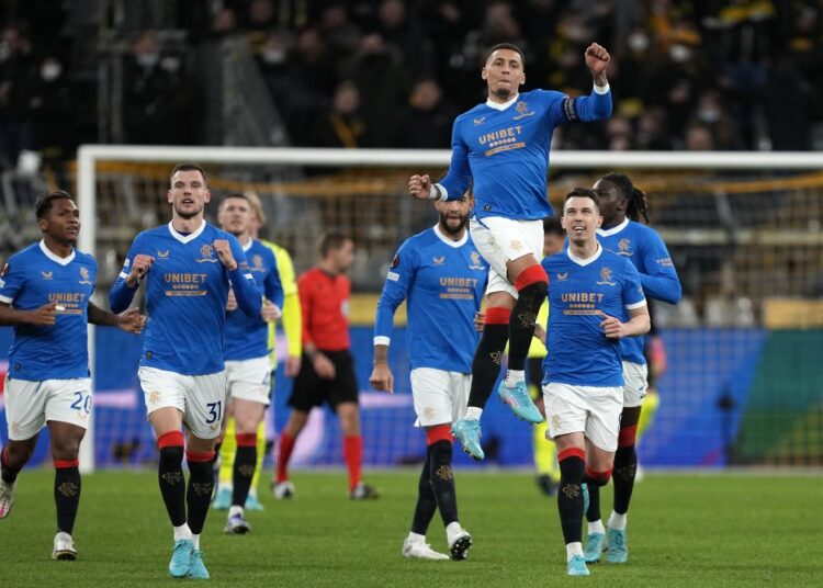 Rangers' James Tavernier, up, celebrates after scoring the opening goal with a penalty against Borussia Dortmund during their UEFA Europa League Play-off, 1st leg match in Dortmund.