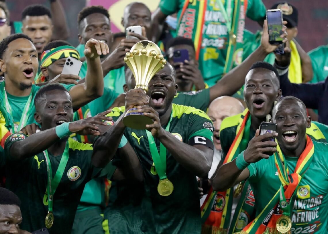 Senegal's players celebrate with trophy after winning the AFCON final in Yaounde.