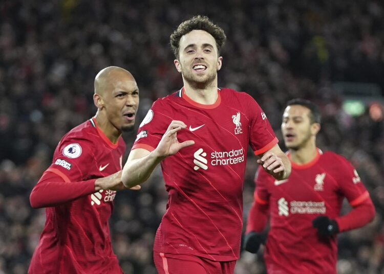 Liverpool's Diogo Jota (C) celebrates with his teammate Fabinho (L) after scoring his side's opening goal during the English Premier League match against Leicester City at Anfield stadium in Liverpool.