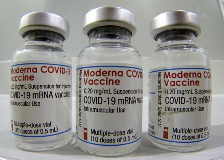 Vials of the Moderna COVID-19 vaccine are displayed on a counter at a pharmacy in Portland.