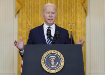 Biden hits Russia with sanctions, shifts troops to Germany
