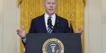 Biden hits Russia with sanctions, shifts troops to Germany