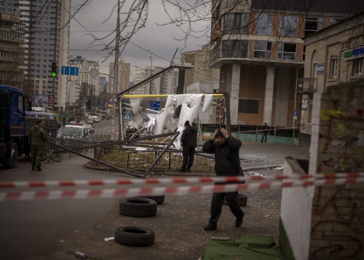 Police officers inspect area after an apparent Russian strike in Kyiv Ukraine, on Thursday, February 24, 2022.