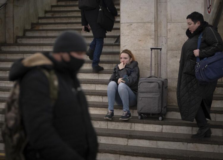 Fear, calm among Ukrainians as Russian troops enter 1 - Egyptian Gazette People walk in a subway to get a train as they leave the city of Kyiv, Ukraine, on Thursday, February 24, 2022.