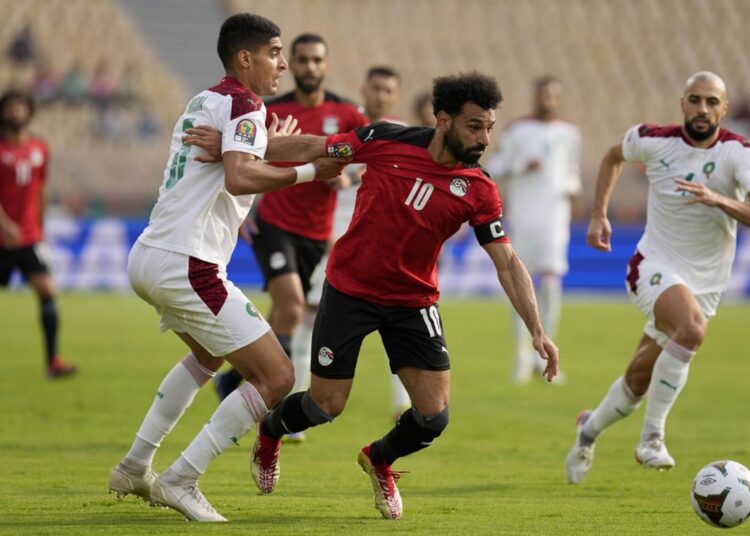 Egypt's Mohamed Salah holds off the challenge of Adam Masina of Morocco during their African Cup of Nations quarter-final match.