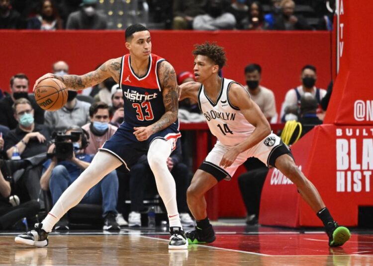 Washington Wizards forward Kyle Kuzma (33) dribbles as Brooklyn Nets forward Kessler Edwards (14) defends during the first half at Capital One Arena, Washington.