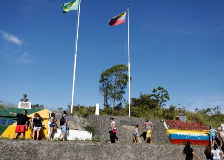 A file photo showing people stand at the border with Venezuela, seen from the Brazilian city of Pacaraima, Roraima state, Brazil on November 16, 2017.