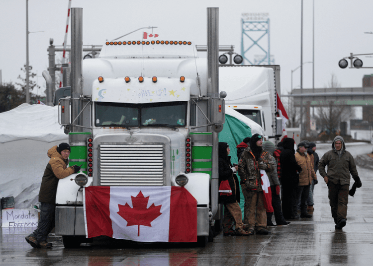 Canadian Prime Minister vows to end trucker blockades 1 - Egyptian Gazette Truckers and supporters block the access leading from the Ambassador Bridge, linking Detroit and Windsor, as truckers and their supporters continue to protest against COVID-19 vaccine mandates and restrictions, in Windsor, Ontario, on Feb. 11, 2022.