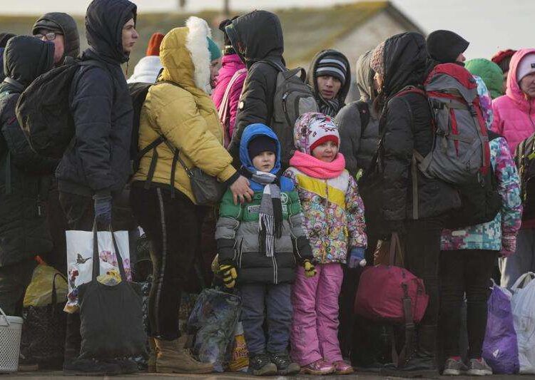 Refugees stay in a group after fleeing the war from neighbouring Ukraine at the border crossing in Palanca, Moldova, on March 10, 2022.